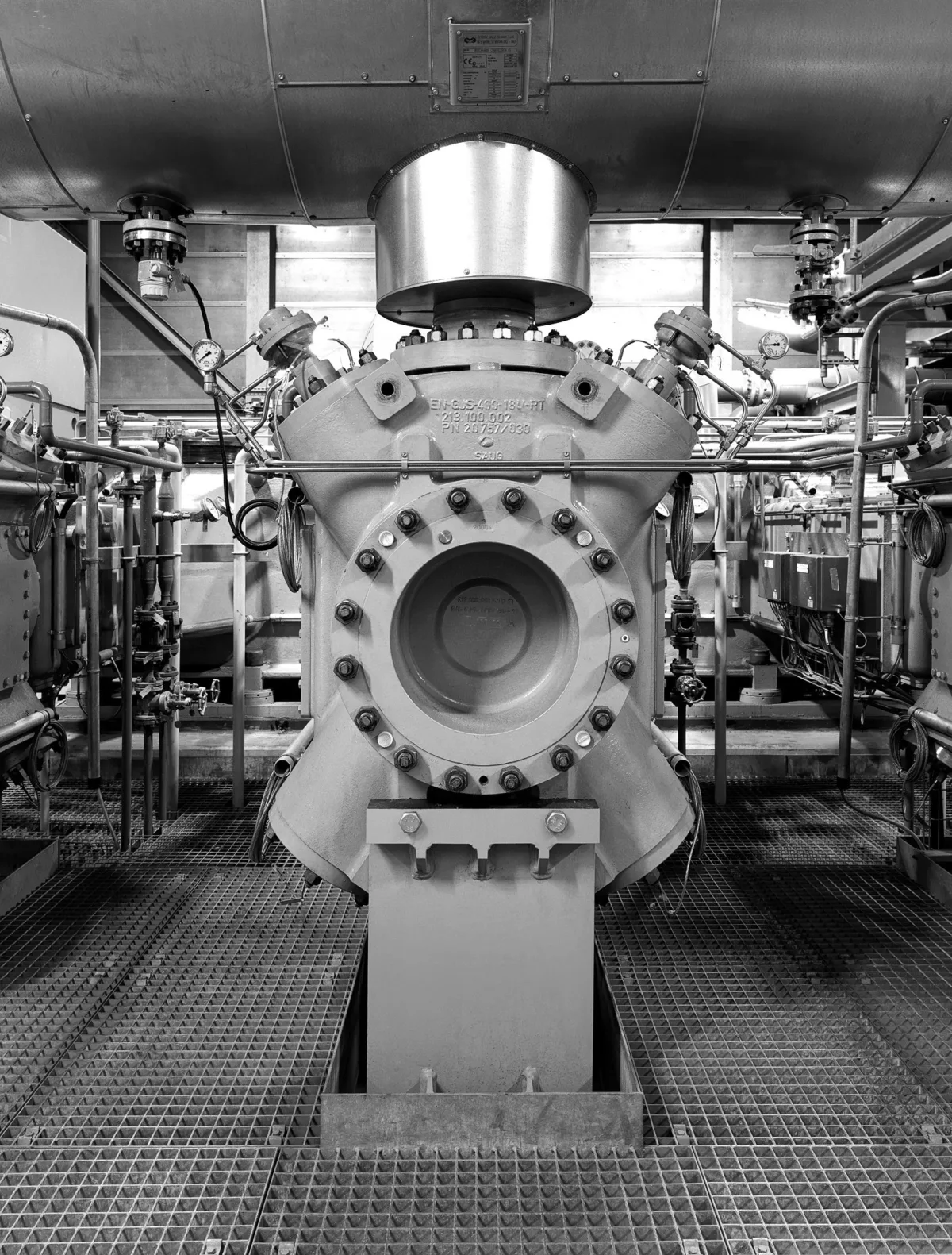 Complete reciprocating compressor unit on a steel grating floor, Burckhardt Compression, Ningbo, China, industrial photography by Scanderbeg Sauer