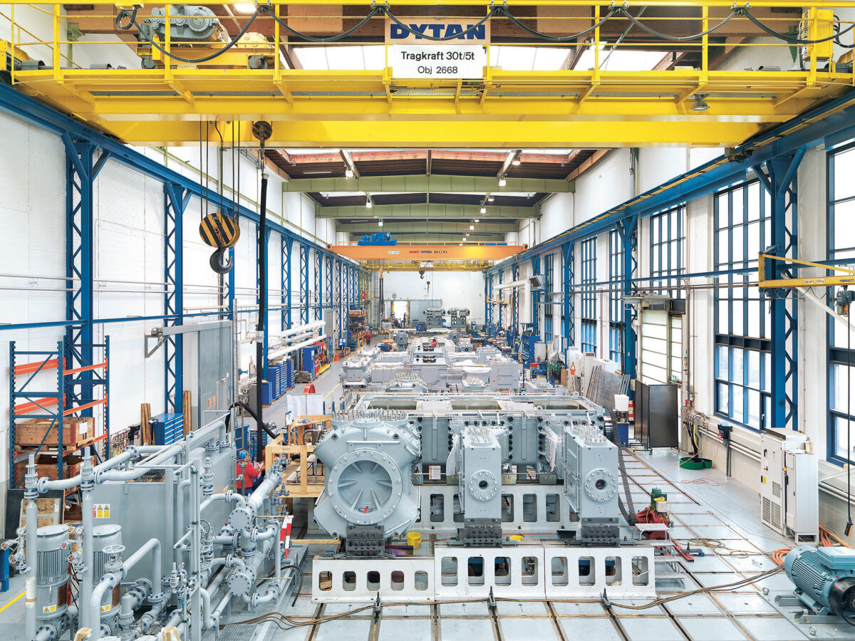 Compressor assembly hall with units in production and overhead crane, Burckhardt Compression, Winterthur, industrial photography by Scanderbeg Sauer