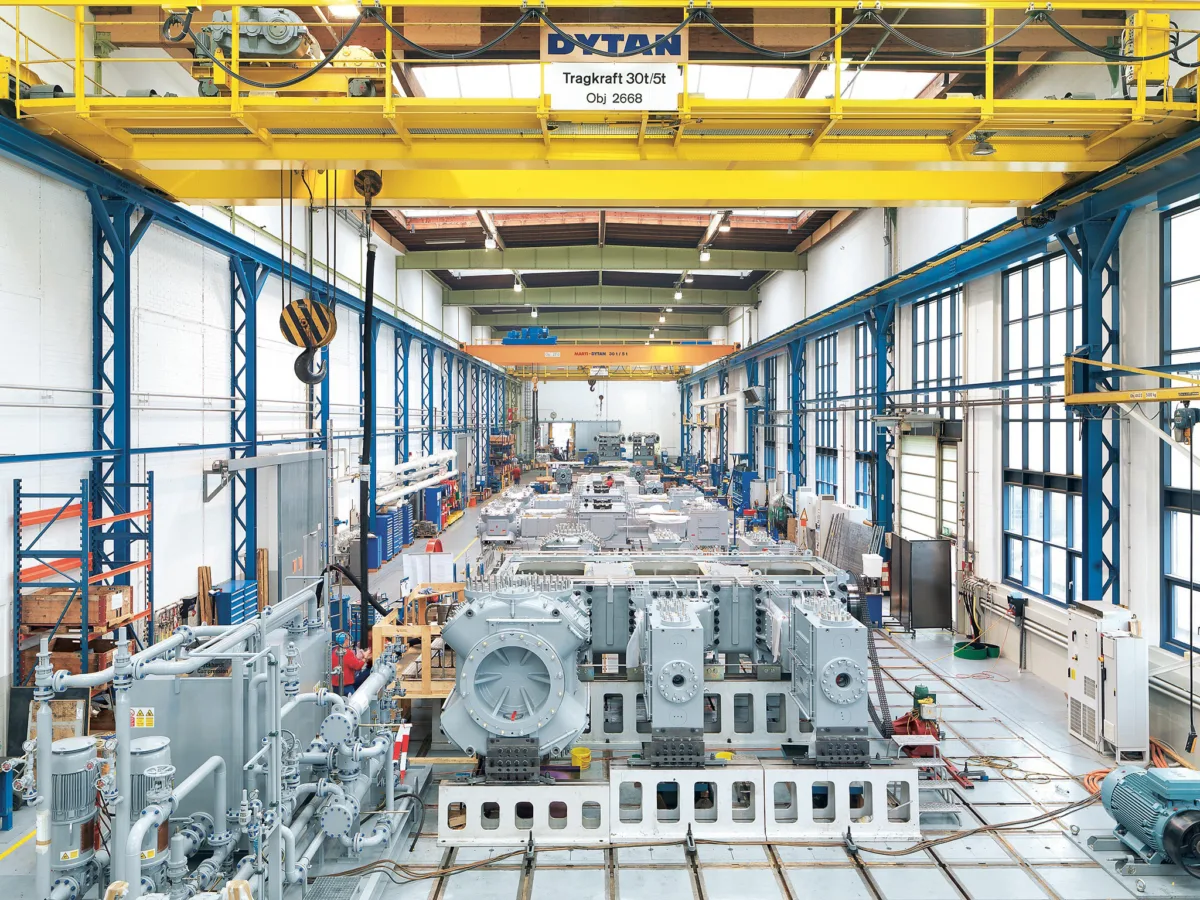 Compressor assembly hall with units in production and overhead crane, Burckhardt Compression, Winterthur, industrial photography by Scanderbeg Sauer