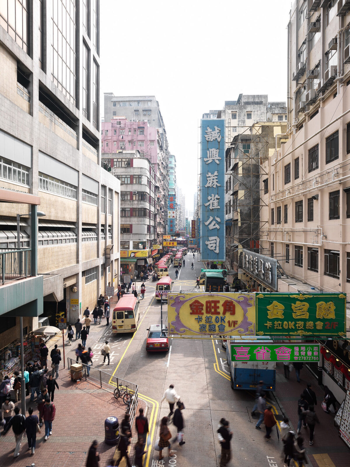 Dense urban street scene with neon signs in Kowloon, Hong Kong, cityscape photography by Scanderbeg Sauer