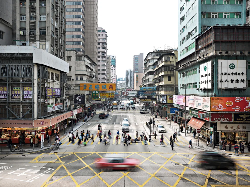 Busy intersection seen from above with pedestrians and traffic, Kowloon, Hong Kong, cityscape photography by Scanderbeg Sauer