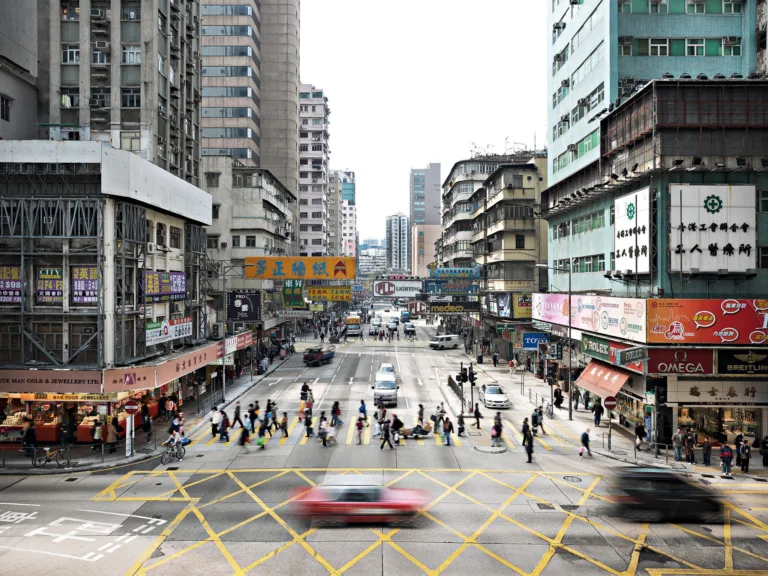 Busy intersection seen from above with pedestrians and traffic, Kowloon, Hong Kong, cityscape photography by Scanderbeg Sauer