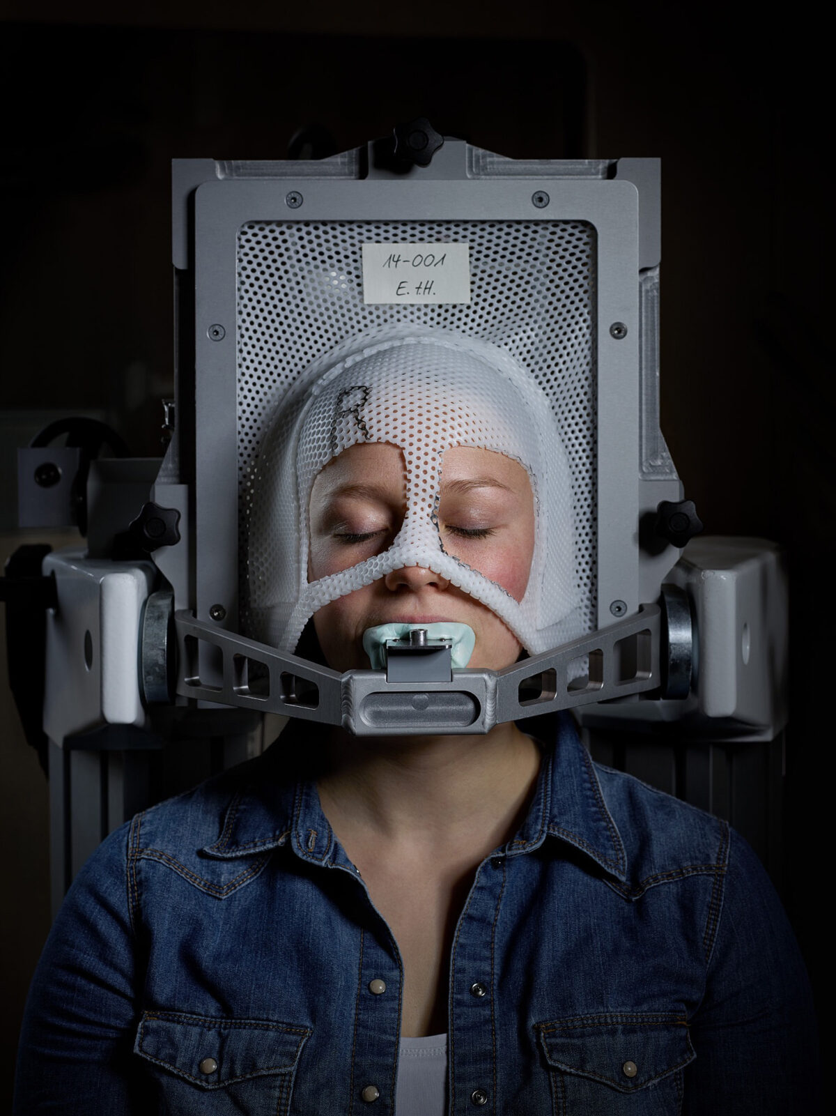 Patient in a thermoplastic mask during proton therapy, Paul Scherrer Institute, Villigen, Switzerland, research photography by Scanderbeg Sauer