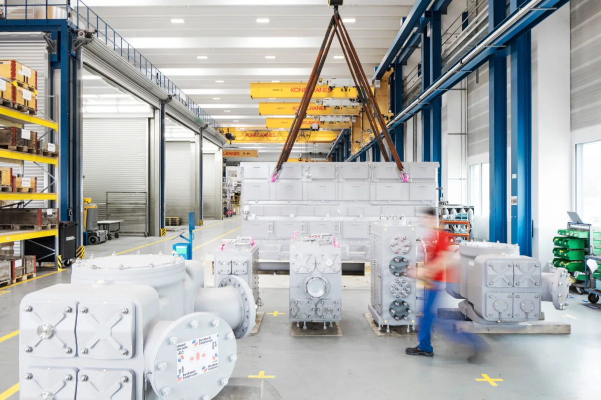 Finished compressor packages staged in the assembly hall with overhead crane, Burckhardt Compression, Winterthur, industrial photography by Scanderbeg Sauer