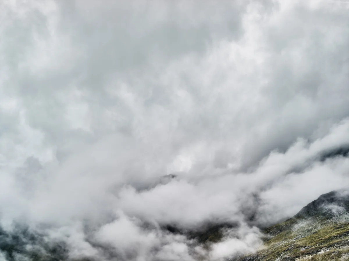 Clouds drifting over a mountain slope, Furka Pass, Obergoms, Switzerland, landscape photography by Scanderbeg Sauer