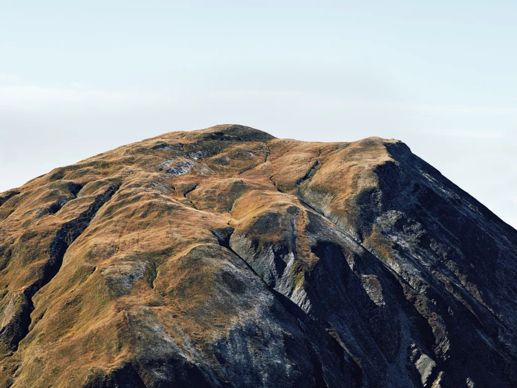 Barren mountain ridge in evening light, Furka Pass, Obergoms, Switzerland, landscape photography by Scanderbeg Sauer