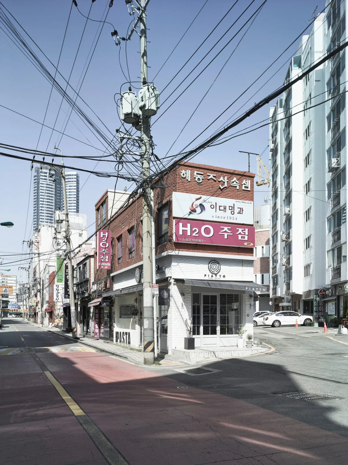 Street corner with shopfronts, Busan, South Korea, street photography by Scanderbeg Sauer