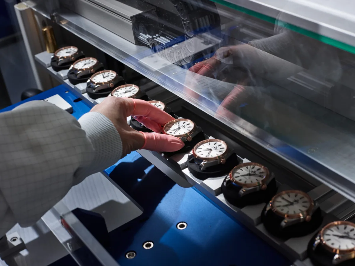 Handling finished watches on the assembly line, Omega, Bienne, Switzerland, watchmaking photography by Scanderbeg Sauer