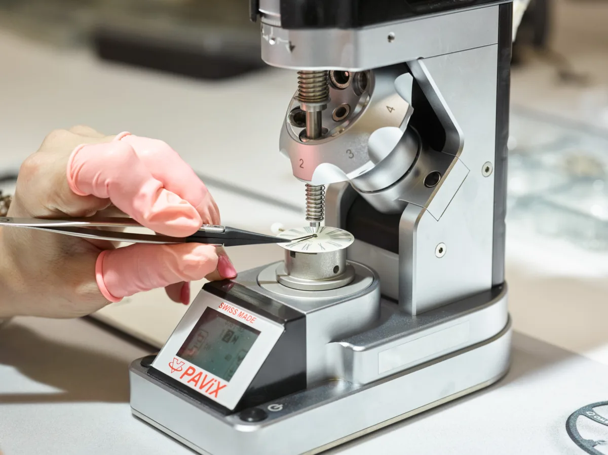 Watchmaker at a precision fitting press, Omega, Bienne, Switzerland, watchmaking photography by Scanderbeg Sauer