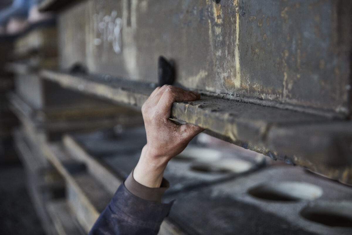 Workers hand finishing a casting mould in the foundry, Shenyang Yuanda Foundry, Shenyang, China, industrial photography by Scanderbeg Sauer
