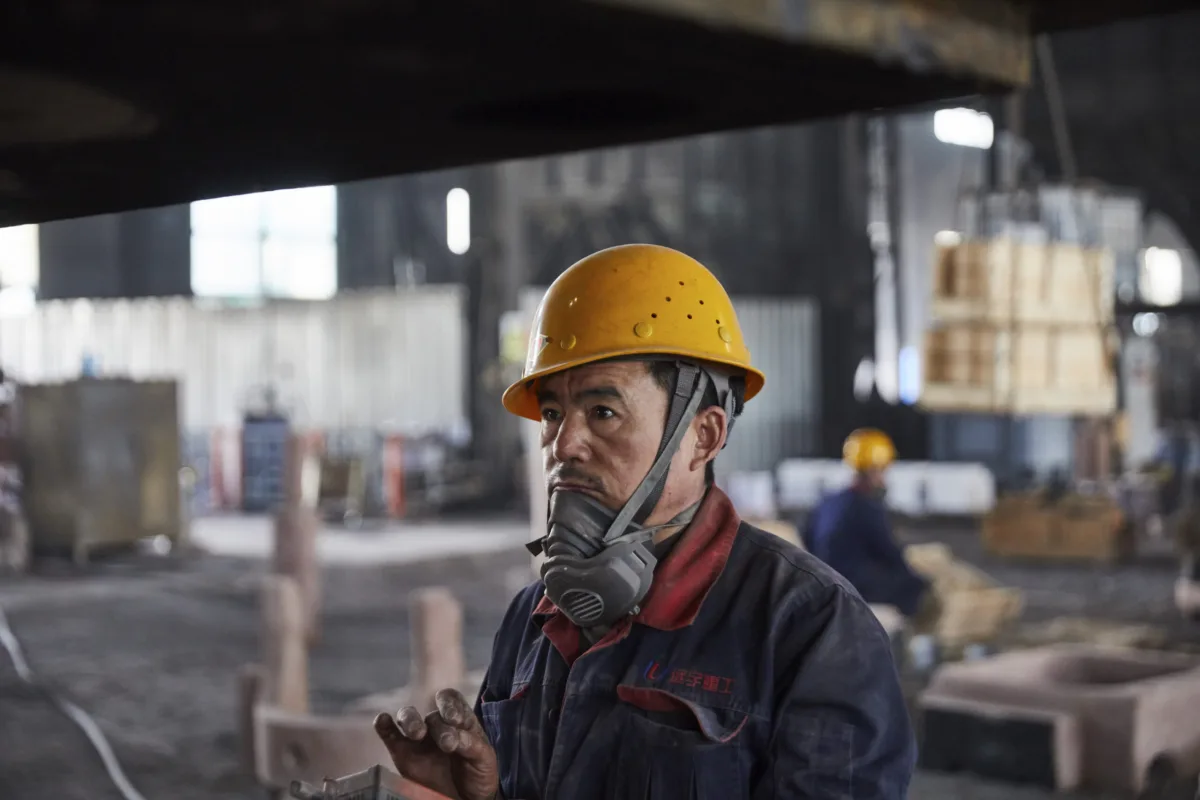 Foundry worker portrait with hard hat and respirator, Shenyang Yuanda Foundry, Shenyang, China, industrial photography by Scanderbeg Sauer
