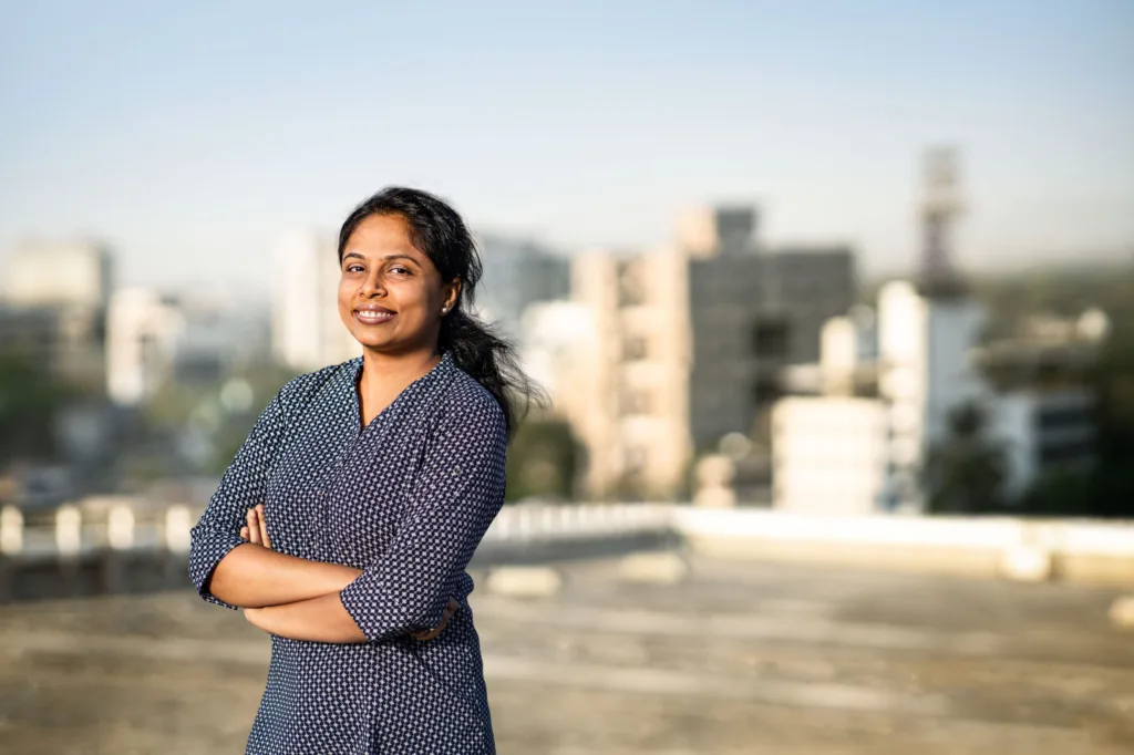 Employee portrait on the rooftop with the Pune skyline behind, Burckhardt Compression, Pune, India, industrial photography by Scanderbeg Sauer