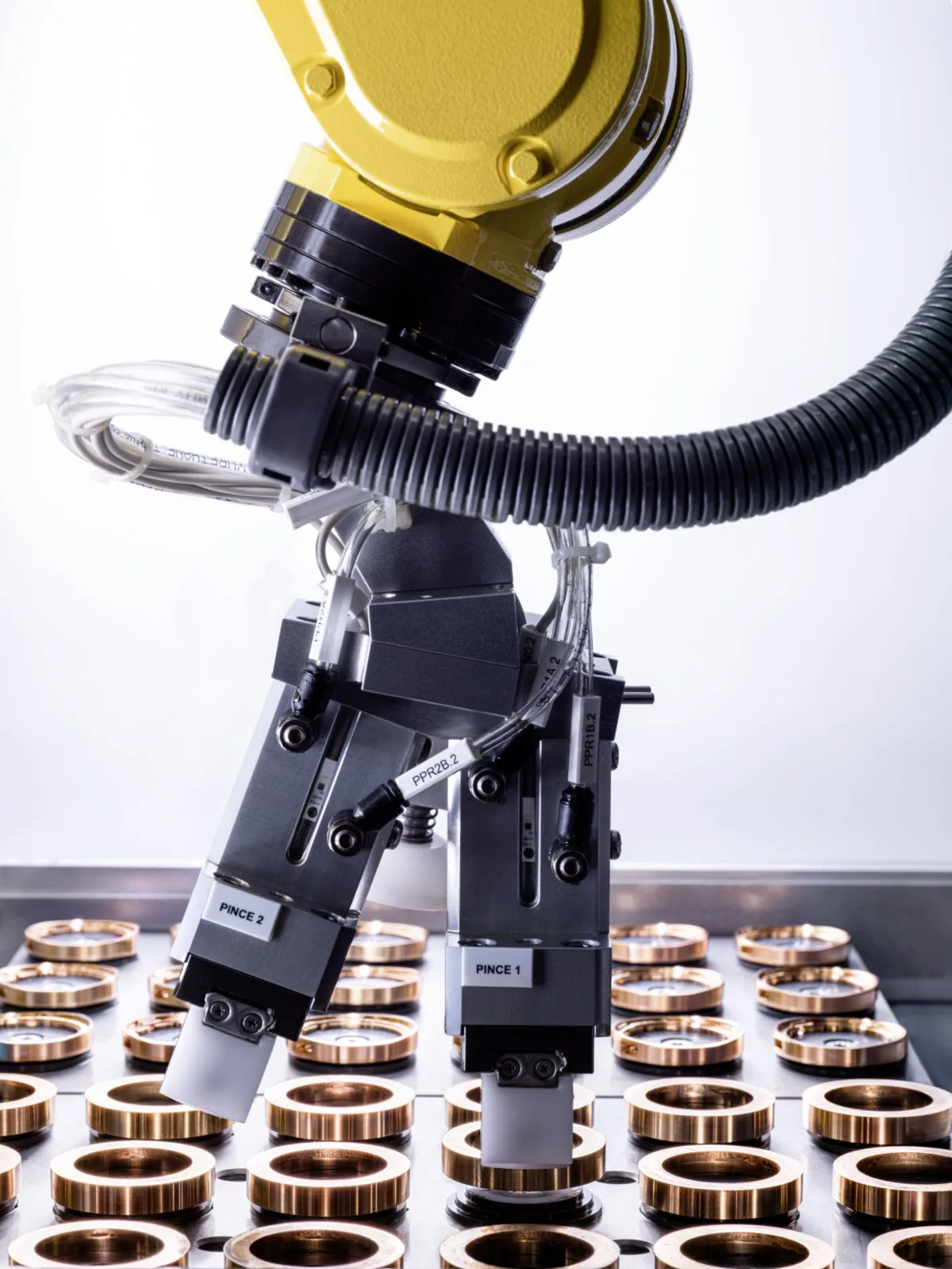 Watchmaking photography, Audemars Piguet robotic arm above watch case blanks production line, Le Brassus, by Scanderbeg Sauer