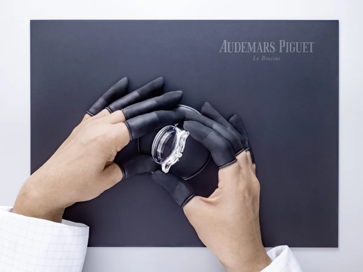 Watchmaking photography, Audemars Piguet Code 11.59 watch held in gloved hands, Le Brassus, by Scanderbeg Sauer