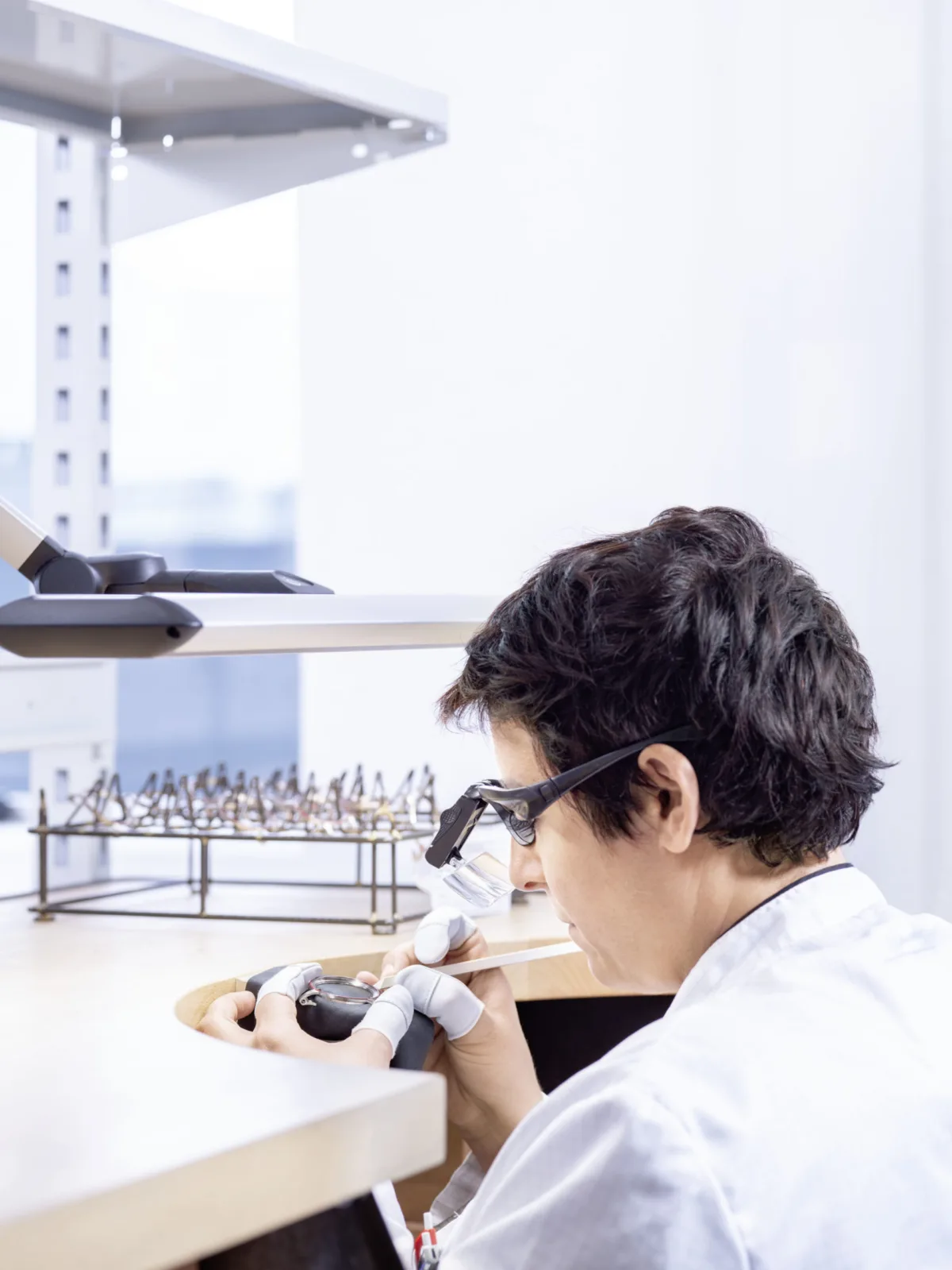 Watchmaking photography, Audemars Piguet watchmaker at work with loupe in manufacture atelier, Le Brassus, by Scanderbeg Sauer