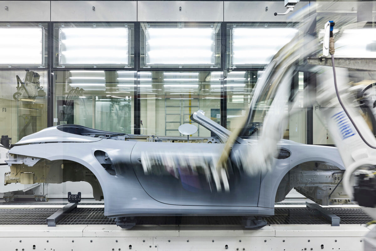 Automotive photography, paint robot arm in motion on Porsche 911 Cabriolet body, Zuffenhausen, automotive photography by Scanderbeg Sauer