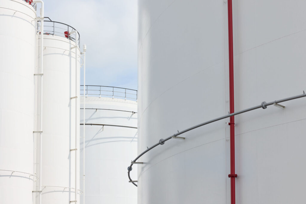 Industrial tank detail with red pipe at Ambrian Energy Bremen, industrial photography by Scanderbeg Sauer