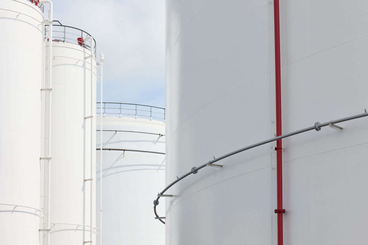 Industrial tank detail with red pipe at Ambrian Energy Bremen, industrial photography by Scanderbeg Sauer