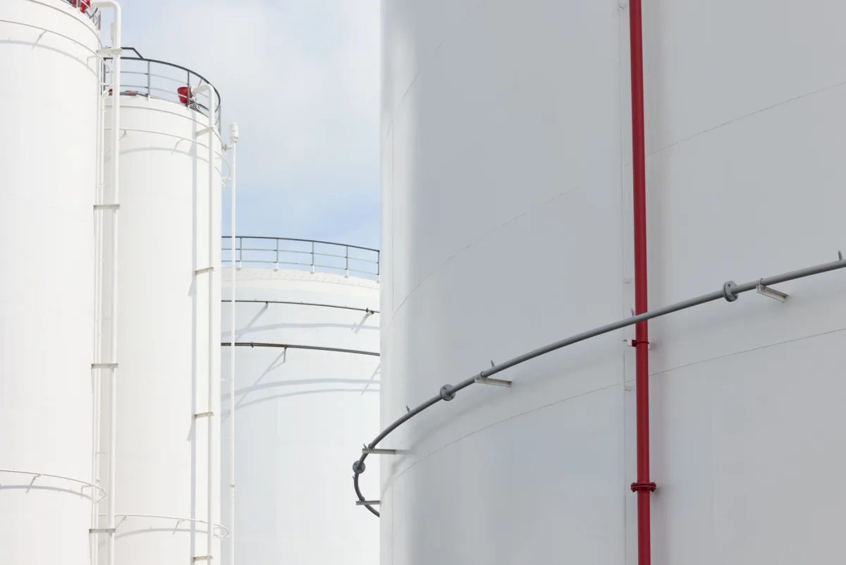 Industrial tank detail with red pipe at Ambrian Energy Bremen, industrial photography by Scanderbeg Sauer