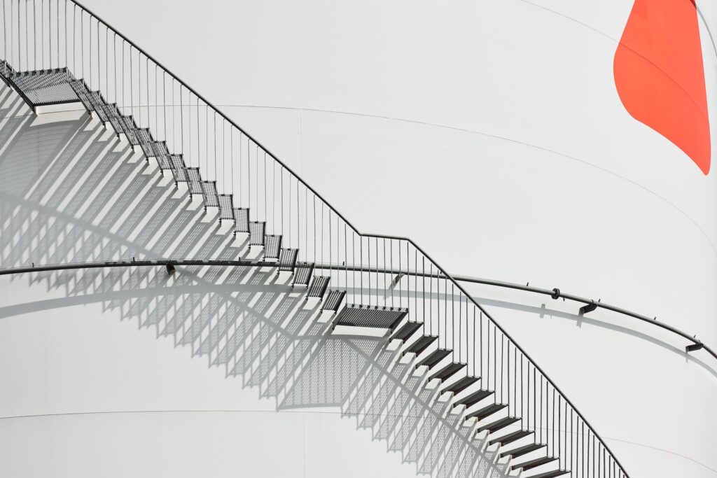 Detail of external staircase on storage tank at Ambrian Energy Bremen, industrial photography by Scanderbeg Sauer