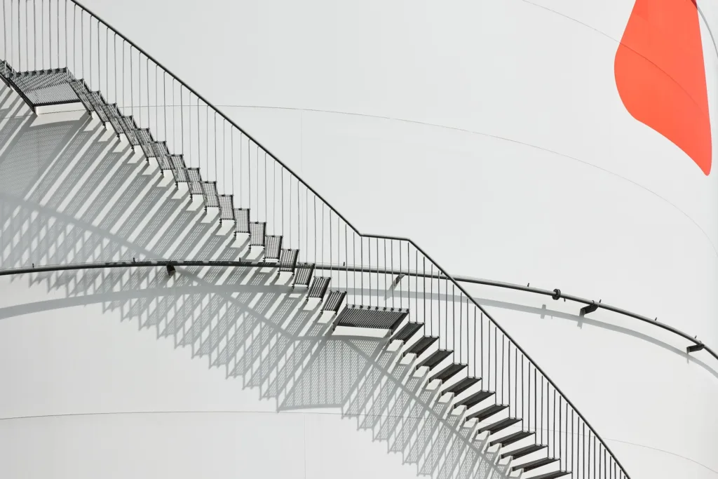 Detail of external staircase on storage tank at Ambrian Energy Bremen, industrial photography by Scanderbeg Sauer