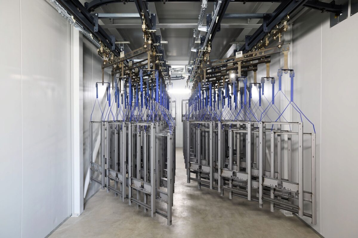 Coating facility with suspended frames on overhead conveyor, Geberit, Lichtenstein, industrial photography by Scanderbeg Sauer