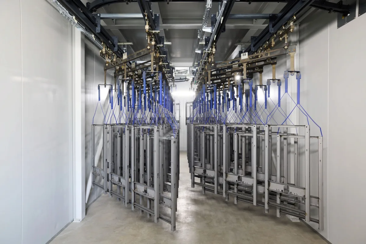 Coating facility with suspended frames on overhead conveyor, Geberit, Lichtenstein, industrial photography by Scanderbeg Sauer