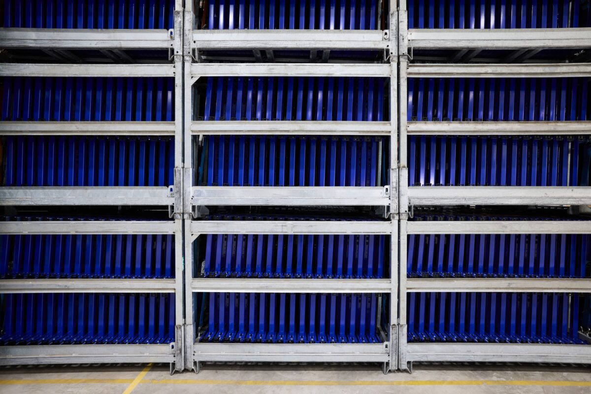 Blue Duofix frames on overhead conveyor coating line, Geberit, Lichtenstein, industrial photography by Scanderbeg Sauer