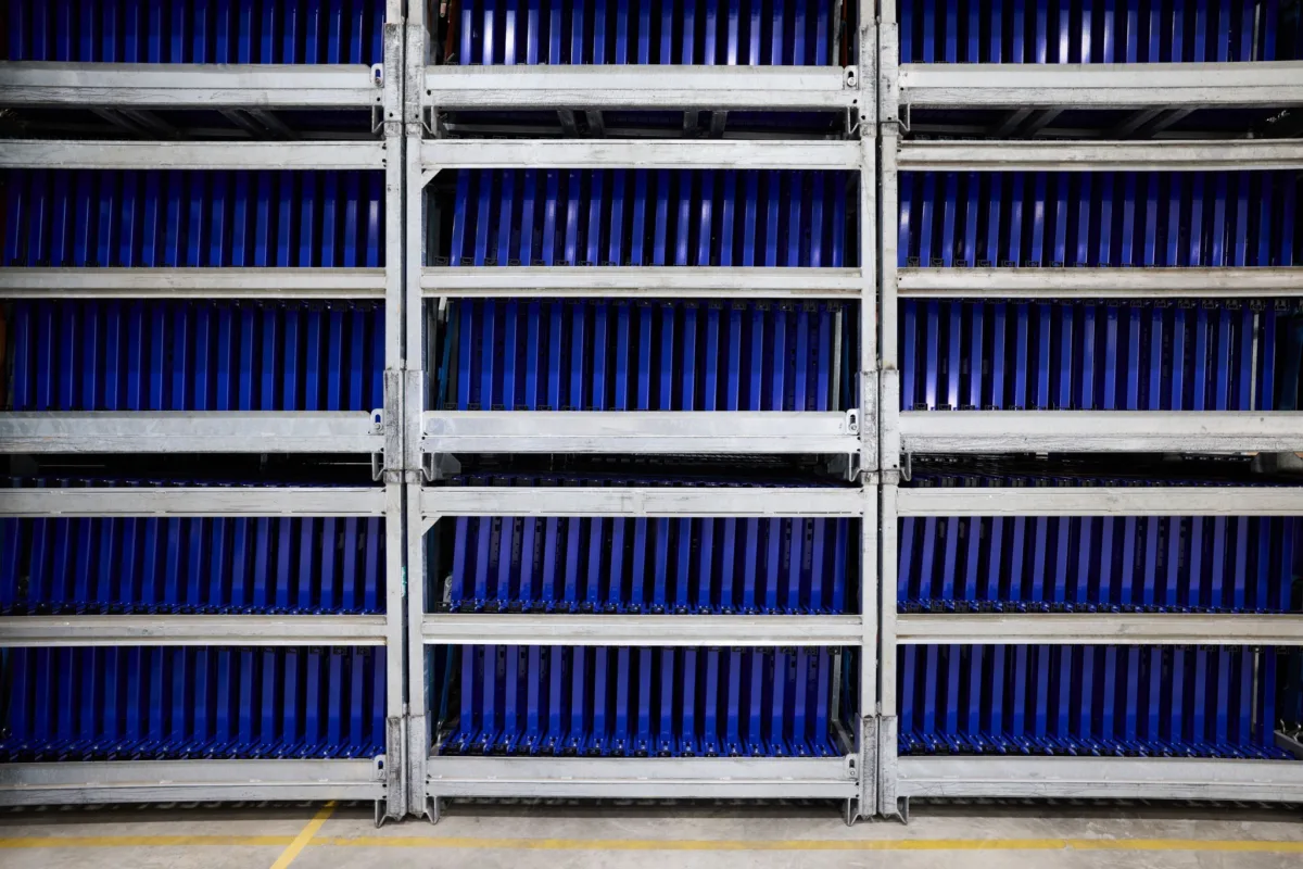 Blue Duofix frames on overhead conveyor coating line, Geberit, Lichtenstein, industrial photography by Scanderbeg Sauer